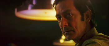 Movie still from “My Blueberry Nights” (2007), directed by Kar-Wai Wong – A man's face in a dimly - lit room; Close Up shot, Low angle