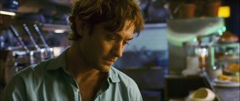 Movie still from “My Blueberry Nights” (2007), directed by Kar-Wai Wong – A person wearing a blue shirt; Close Up shot, Over the shoulder angle