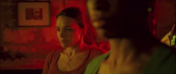 Movie still from “My Blueberry Nights” (2007), directed by Kar-Wai Wong – A woman looking into a mirror in a red room; Close Up shot, Low angle