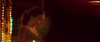 Movie still from “My Blueberry Nights” (2007), directed by Kar-Wai Wong – A beautiful young lady standing next to a candle; Close Up shot, Over the shoulder angle