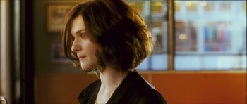 Movie still from “My Blueberry Nights” (2007), directed by Kar-Wai Wong – A person wearing a black shirt; Close Up shot, Over the shoulder angle