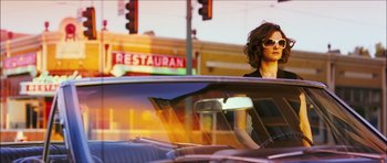 Movie still from “My Blueberry Nights” (2007), directed by Kar-Wai Wong – A woman sitting in the driver's seat of a car; Medium shot, Low angle
