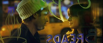 Movie still from “My Blueberry Nights” (2007), directed by Kar-Wai Wong – A man and a woman face to face in front of a neon sign; Close Up shot, Over the shoulder angle