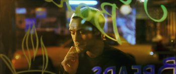 Movie still from “My Blueberry Nights” (2007), directed by Kar-Wai Wong – A young man is sitting in front of a window; Close Up shot, Over the shoulder angle