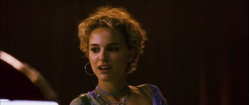 Movie still from “My Blueberry Nights” (2007), directed by Kar-Wai Wong – A person wearing a necklace; Close Up shot, Over the shoulder angle