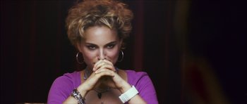 Movie still from “My Blueberry Nights” (2007), directed by Kar-Wai Wong – A beautiful woman in a purple shirt holding her hands to her face; Close Up shot, Over the shoulder angle