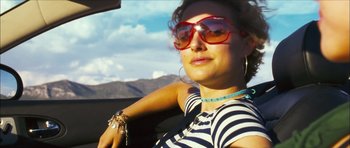 Movie still from “My Blueberry Nights” (2007), directed by Kar-Wai Wong – A woman in a car wearing sunglasses and a necklace; Close Up shot, Low angle