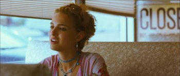 Movie still from “My Blueberry Nights” (2007), directed by Kar-Wai Wong – A woman sitting in front of a window; Close Up shot, Over the shoulder angle