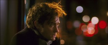 Movie still from “My Blueberry Nights” (2007), directed by Kar-Wai Wong – A person wearing a jacket; Close Up shot, Over the shoulder angle