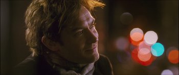 Movie still from “My Blueberry Nights” (2007), directed by Kar-Wai Wong – A person wearing a scarf; Close Up shot, Over the shoulder angle