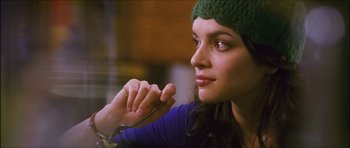 Movie still from “My Blueberry Nights” (2007), directed by Kar-Wai Wong – A beautiful young lady wearing a green hat; Close Up shot, Over the shoulder angle