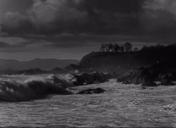 Movie still from “My Cousin Rachel” (1952), directed by Henry Koster – A black - and - white photo of waves crashing on the shore; Extreme Wide shot, Low angle