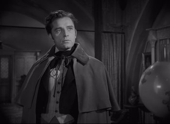 Movie still from “My Cousin Rachel” (1952), directed by Henry Koster – A black and white photo of a man in a cape; Medium shot, Low angle