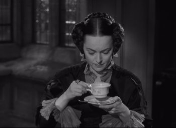 Movie still from “My Cousin Rachel” (1952), directed by Henry Koster – A black and white photo of a woman holding a tea cup; Close Up shot, High angle