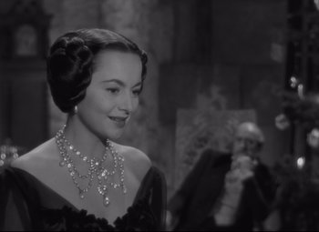 Movie still from “My Cousin Rachel” (1952), directed by Henry Koster – A woman in a black dress and a necklace; Close Up shot, Over the shoulder angle