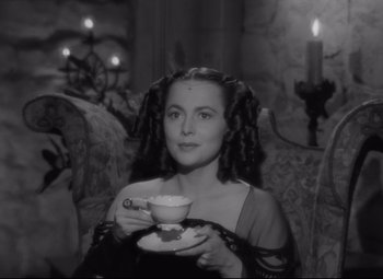 Movie still from “My Cousin Rachel” (1952), directed by Henry Koster – A black and white photo of a woman holding a tea cup; Close Up shot, High angle