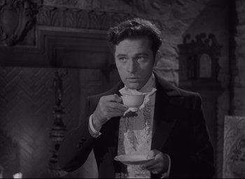Movie still from “My Cousin Rachel” (1952), directed by Henry Koster – A black and white photo of a man drinking a cup of tea; Medium shot, Low angle