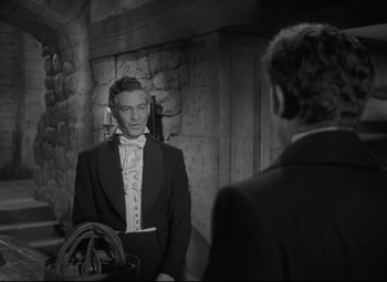 Movie still from “My Cousin Rachel” (1952), directed by Henry Koster – A man in a tuxedo looking at himself in the mirror; Medium shot, Over the shoulder angle