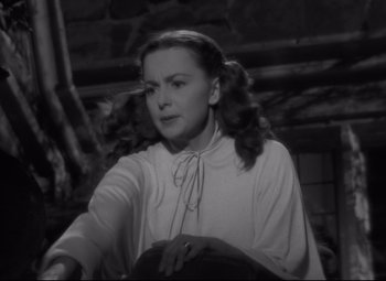 Movie still from “My Cousin Rachel” (1952), directed by Henry Koster – A black - and - white photo of a woman in a white blouse; Close Up shot, Over the shoulder angle