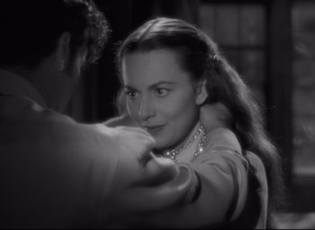 Movie still from “My Cousin Rachel” (1952), directed by Henry Koster – A black - and - white photo of a woman and a man; Close Up shot, Over the shoulder angle