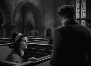 Movie still from “My Cousin Rachel” (1952), directed by Henry Koster – A woman wearing a top hat sitting next to a man; Medium shot, Over the shoulder angle