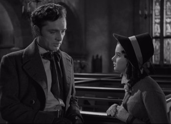 Movie still from “My Cousin Rachel” (1952), directed by Henry Koster – A man and a woman sitting on a bench in front of each other; Medium shot, Over the shoulder angle