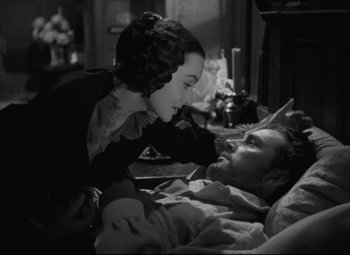 Movie still from “My Cousin Rachel” (1952), directed by Henry Koster – A man laying in a bed with a woman; Medium shot, Over the shoulder angle