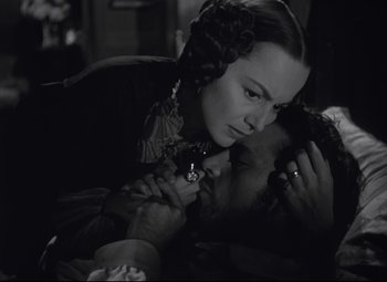 Movie still from “My Cousin Rachel” (1952), directed by Henry Koster – An old photo of a woman and a young man; Close Up shot, Over the shoulder angle