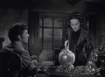 Movie still from “My Cousin Rachel” (1952), directed by Henry Koster – A man and a woman sitting at a table; Medium shot, Over the shoulder angle