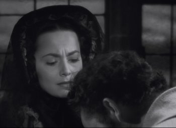 Movie still from “My Cousin Rachel” (1952), directed by Henry Koster – A black and white photo of a woman and a man; Close Up shot, Over the shoulder angle