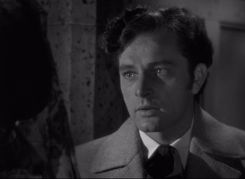 Movie still from “My Cousin Rachel” (1952), directed by Henry Koster – A black and white photo of a man in a suit and tie; Close Up shot, Over the shoulder angle