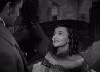 Movie still from “My Cousin Rachel” (1952), directed by Henry Koster – A black and white photo of a woman with a hat; Close Up shot, Over the shoulder angle