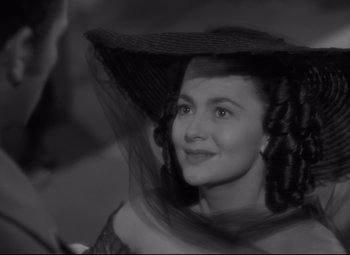 Movie still from “My Cousin Rachel” (1952), directed by Henry Koster – A black and white photo of a woman wearing a hat; Close Up shot, Over the shoulder angle