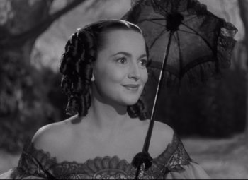 Movie still from “My Cousin Rachel” (1952), directed by Henry Koster – A black and white photo of a woman holding an umbrella; Close Up shot, Over the shoulder angle