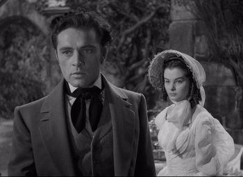 Movie still from “My Cousin Rachel” (1952), directed by Henry Koster – A man and a woman standing next to each other; Medium shot, Over the shoulder angle