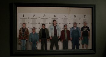 Movie still from “My Cousin Vinny” (1992), directed by Jonathan Lynn – A group of people standing in front of a police wall; Wide shot, Low angle