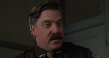 Movie still from “My Cousin Vinny” (1992), directed by Jonathan Lynn – A person with a mustache; Close Up shot, Low angle