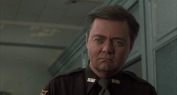Movie still from “My Cousin Vinny” (1992), directed by Jonathan Lynn – A person wearing a police uniform; Close Up shot, Low angle