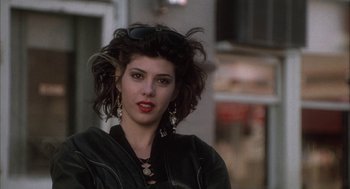 Movie still from “My Cousin Vinny” (1992), directed by Jonathan Lynn – A person wearing sunglasses and a leather jacket; Close Up shot, Over the shoulder angle