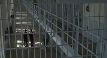 Movie still from “My Cousin Vinny” (1992), directed by Jonathan Lynn – Three people are walking through a jail cell; Extreme Wide shot, High angle