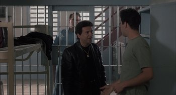 Movie still from “My Cousin Vinny” (1992), directed by Jonathan Lynn – Two men talking to each other in front of a jail cell; Medium shot, Over the shoulder angle