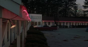 Movie still from “My Cousin Vinny” (1992), directed by Jonathan Lynn – A car parked in front of a motel at night; Extreme Wide shot, High angle