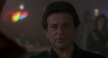 Movie still from “My Cousin Vinny” (1992), directed by Jonathan Lynn – A person wearing a leather jacket; Close Up shot, Over the shoulder angle