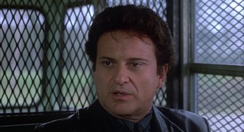 Movie still from “My Cousin Vinny” (1992), directed by Jonathan Lynn – A person wearing a black jacket; Close Up shot, Low angle