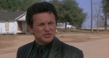 Movie still from “My Cousin Vinny” (1992), directed by Jonathan Lynn – A person wearing a suit and tie; Close Up shot, Low angle