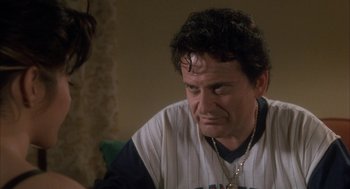 Movie still from “My Cousin Vinny” (1992), directed by Jonathan Lynn – A person sitting on a couch; Close Up shot, Over the shoulder angle