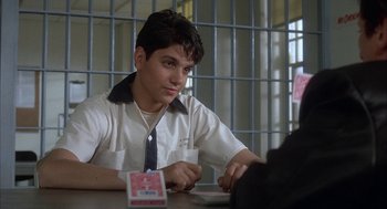 Movie still from “My Cousin Vinny” (1992), directed by Jonathan Lynn – A man sitting at a table in front of a computer; Close Up shot, Over the shoulder angle