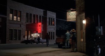 Movie still from “My Cousin Vinny” (1992), directed by Jonathan Lynn – A group of people standing on the side of the street; Wide shot, High angle