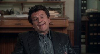 Movie still from “My Cousin Vinny” (1992), directed by Jonathan Lynn – A person wearing a suit and tie; Close Up shot, High angle
