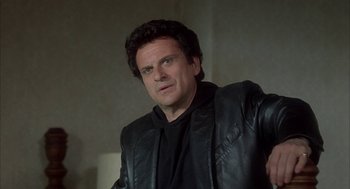 Movie still from “My Cousin Vinny” (1992), directed by Jonathan Lynn – A person wearing a leather jacket; Close Up shot, Over the shoulder angle